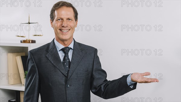 Portrait smiling mature businessman presenting