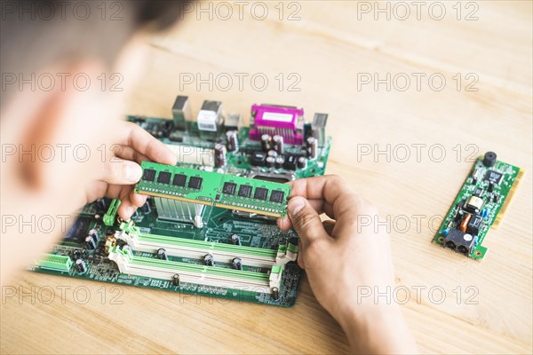 Technician testing ram computer motherboard table