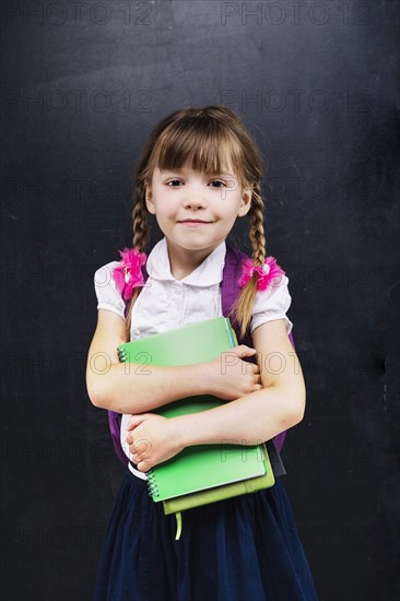 Little schoolgirl with books