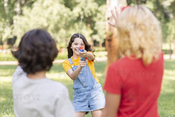 Childrens park playing with water gun