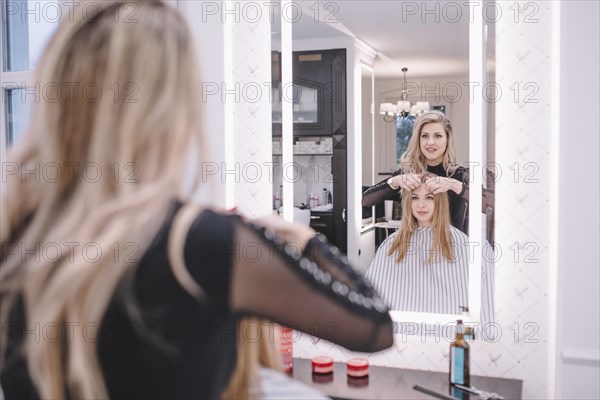 Stylist working with girl salon