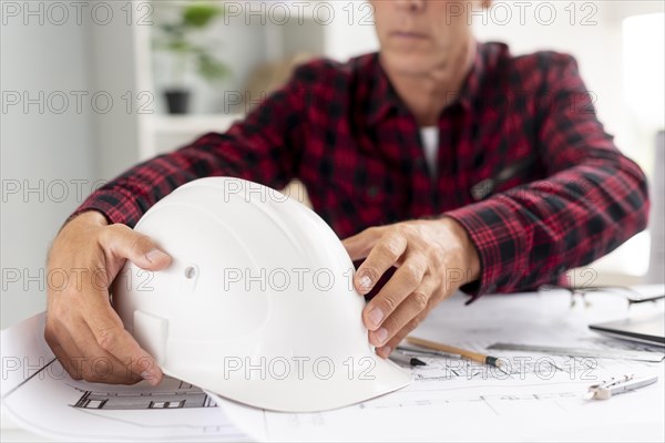 Architect holding his safety helmet