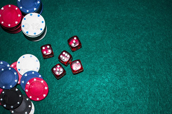 Elevated view red dices casino chips green poker table