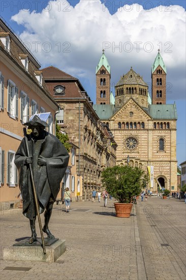 Bronze sculpture Jacob's Pilgrim by Martin Mayer and behind it The Imperial Cathedral of Speyer also called Speyer Cathedral or Cathedral Church of St Mary and St Stephen