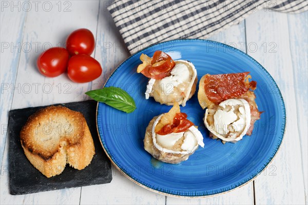 Mushrooms stuffed with goat cheese and iberian cured ham typical spanish tapa