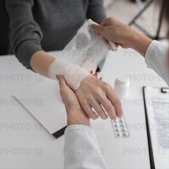 Doctor arranging hand bondage patient