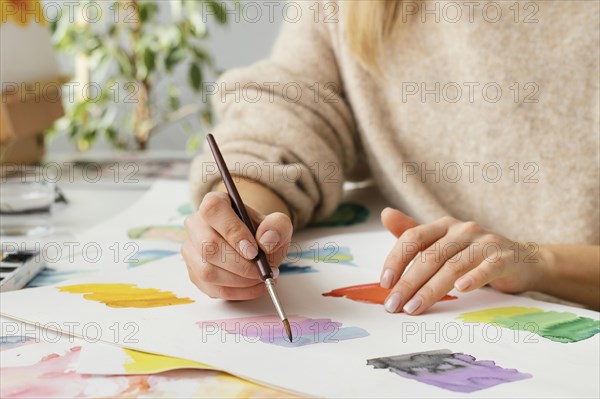 Young woman painting with watercolors