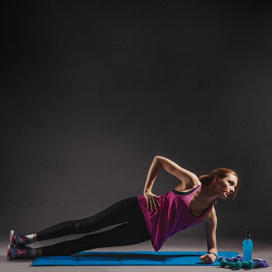 Young woman doing side plank