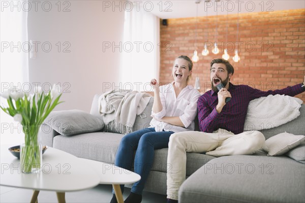 Emotional couple watching tv