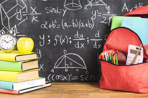 School composition with books backpack table