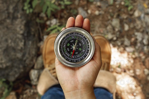 Top view female using compass directions