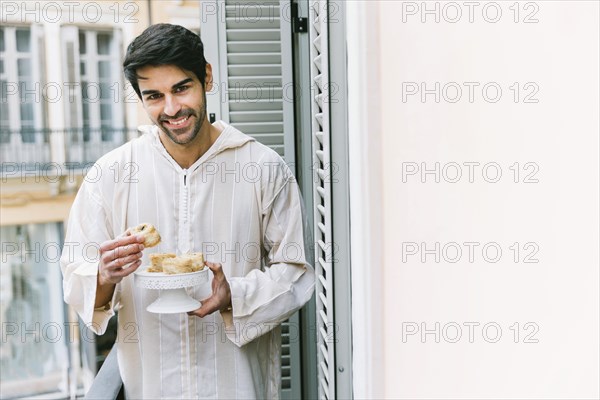 Eid al fitr concept with muslim man eating