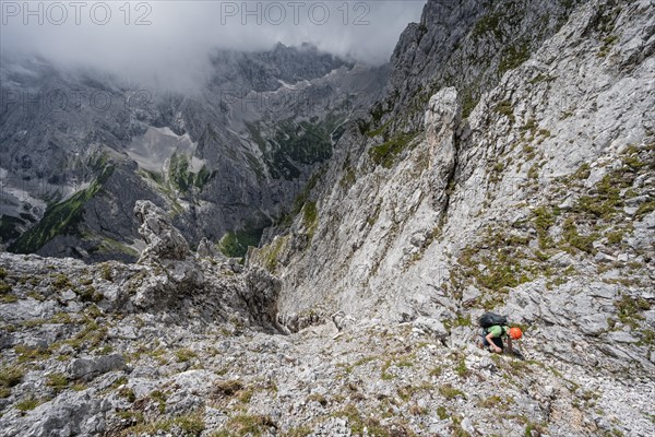 Mountaineer climbing in steep rocky terrain on the way to Waxenstein