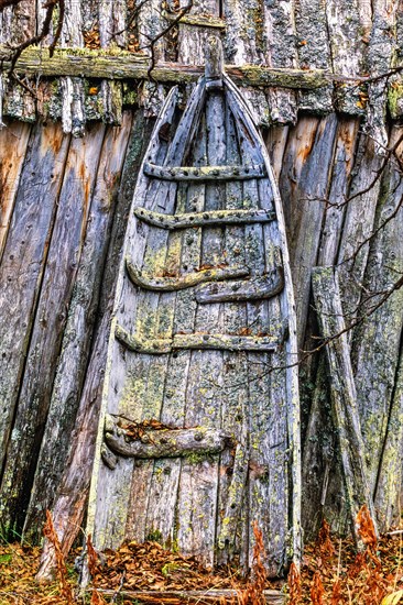Old Sami sled by a shed with lichens