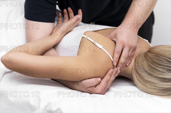 Female patient being given back massage by physiotherapist