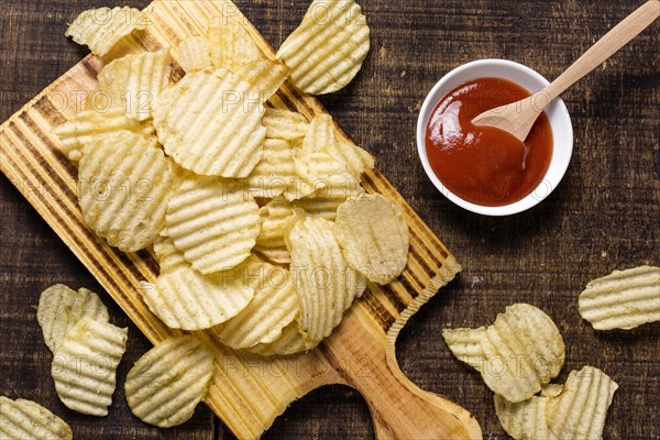 Top view potato chips with ketchup