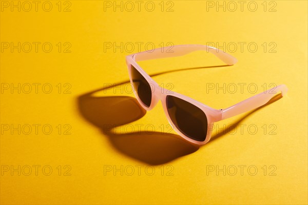 Close up colored sunglasses with shadow