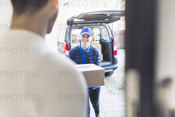 Delivery girl carrying box customer