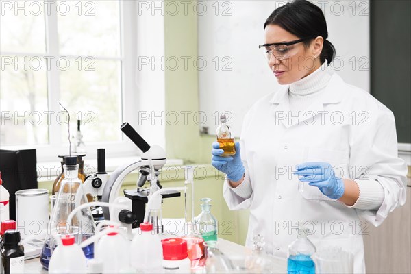 Medium shot woman holding flask