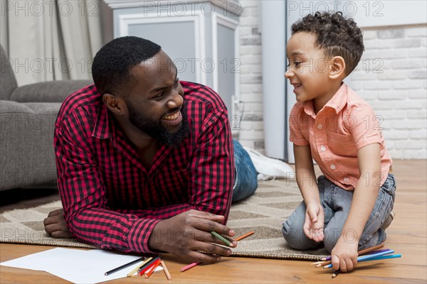 Black father son with pencils floor