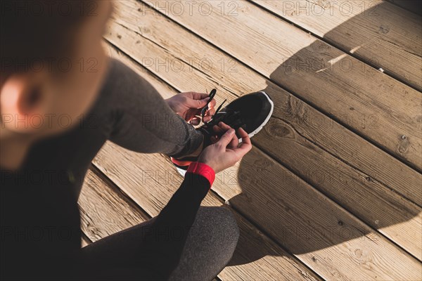 Woman preparing her sneakers before starting run