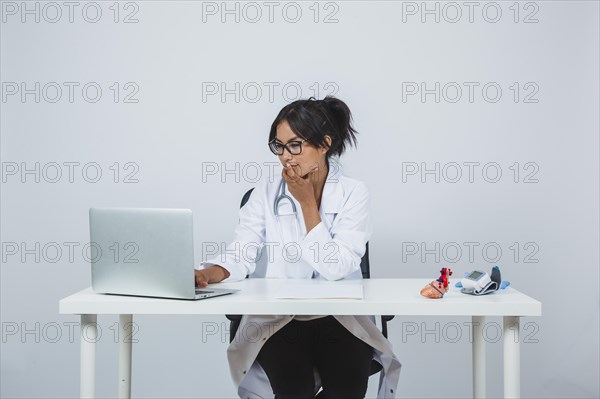 Doctor typing laptop