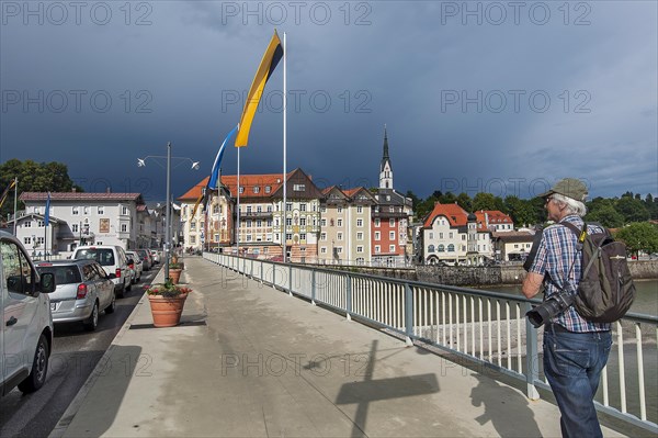 Flag-decorated bridge over the Isar with Gewiierhimmel
