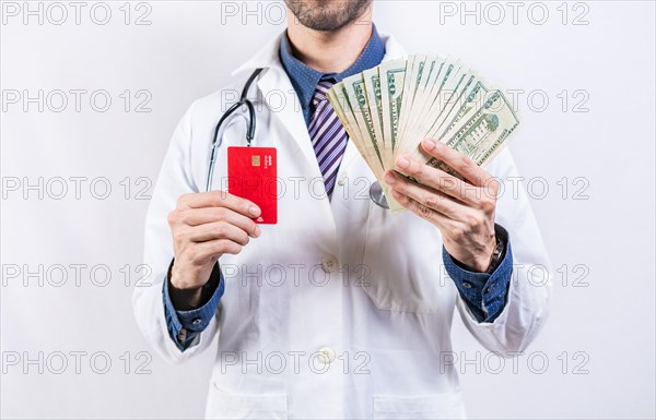 Unrecognizable doctor holding money and credit cards isolated. Doctor hands holding credit card and money isolated