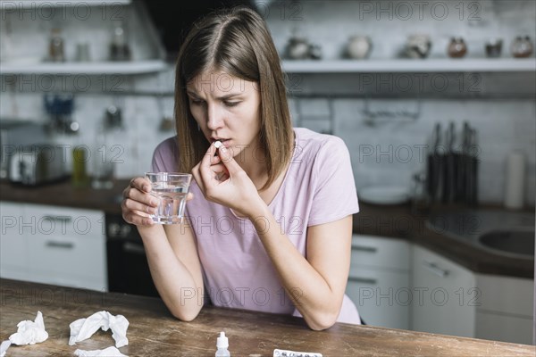 Woman having fever taking medicine home