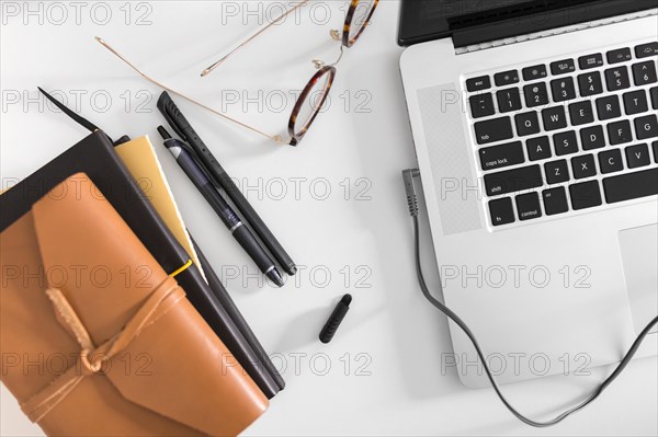 Top view desk with laptop glasses