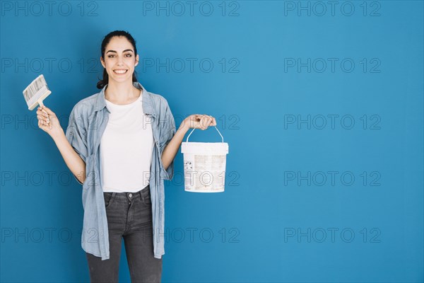 Woman holding brush bucket