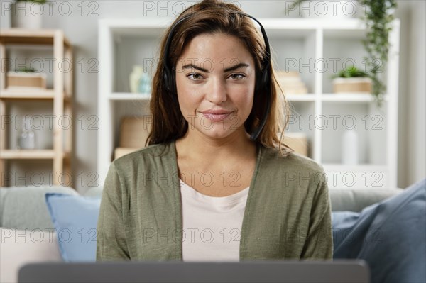 Woman with headset having video call laptop