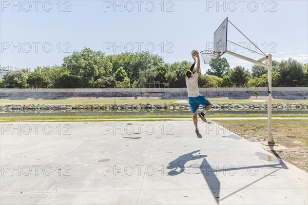 Basketball player throwing basketball hoop