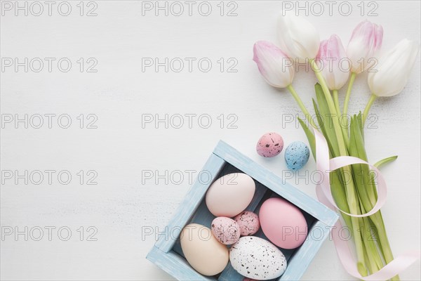 Top view pretty tulips with colorful easter eggs