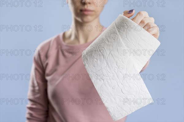 Front view woman holding toilet paper roll