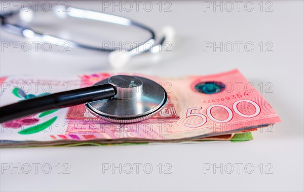 Stethoscope on 500 cordobas bills isolated. Nicaraguan medical healthcare cost concept