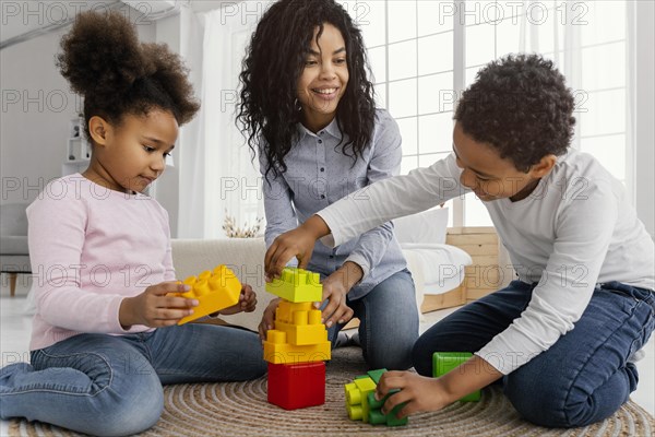 Smiley mother playing home with her children
