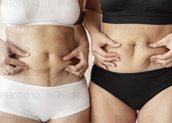 Close up women holding belly