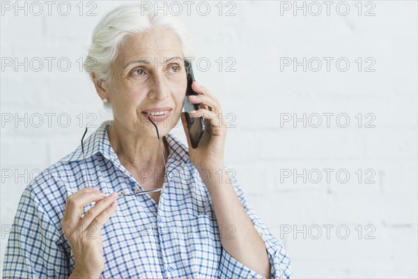 Portrait smiling elderly young woman talking mobile phone