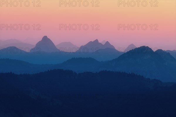 Hilly landscape with mountains Kleiner and Grosser Mythen after sunset