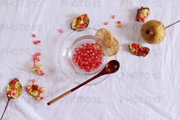 Overhead view of pomegranate fruit and dried lemon slices for making fresh juice