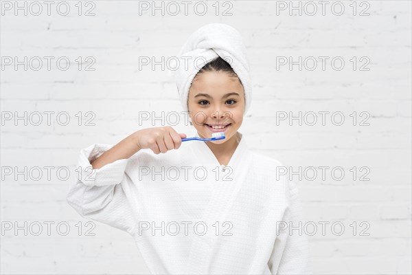 Little kid brushing her teeth