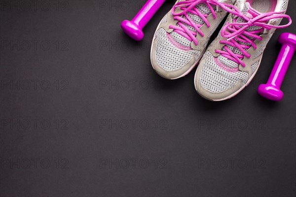 Top view arrangement with pink shoes dumbbells