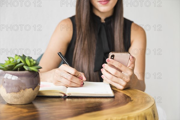 Business woman writing from phone