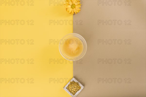Elevated view flowers lemon curd bee pollen dual colored background