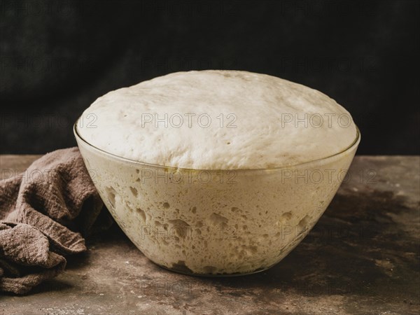 High angle bowl with growing dough pizza