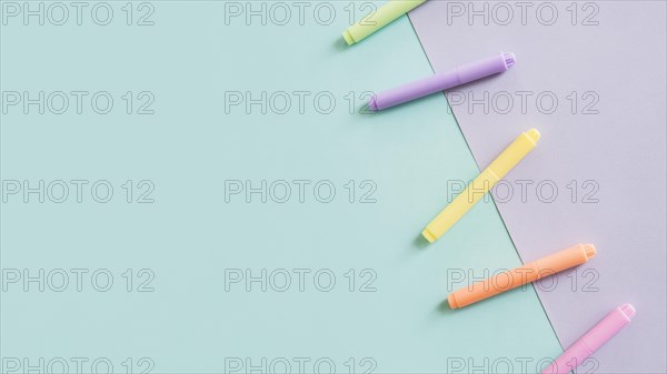 Multi colored markers grey green paper background