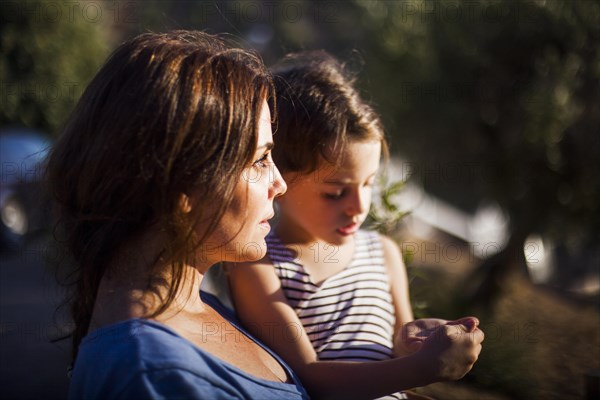 Portrait woman carrying her daughter