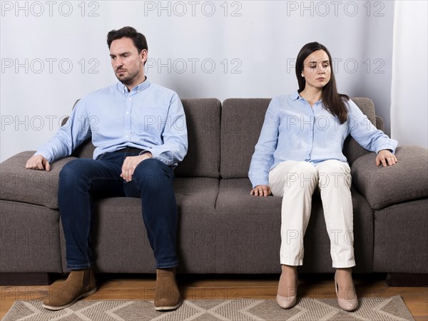 Angry male woman sitting couch