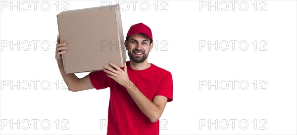 Courier man holding his shoulder big delivery box